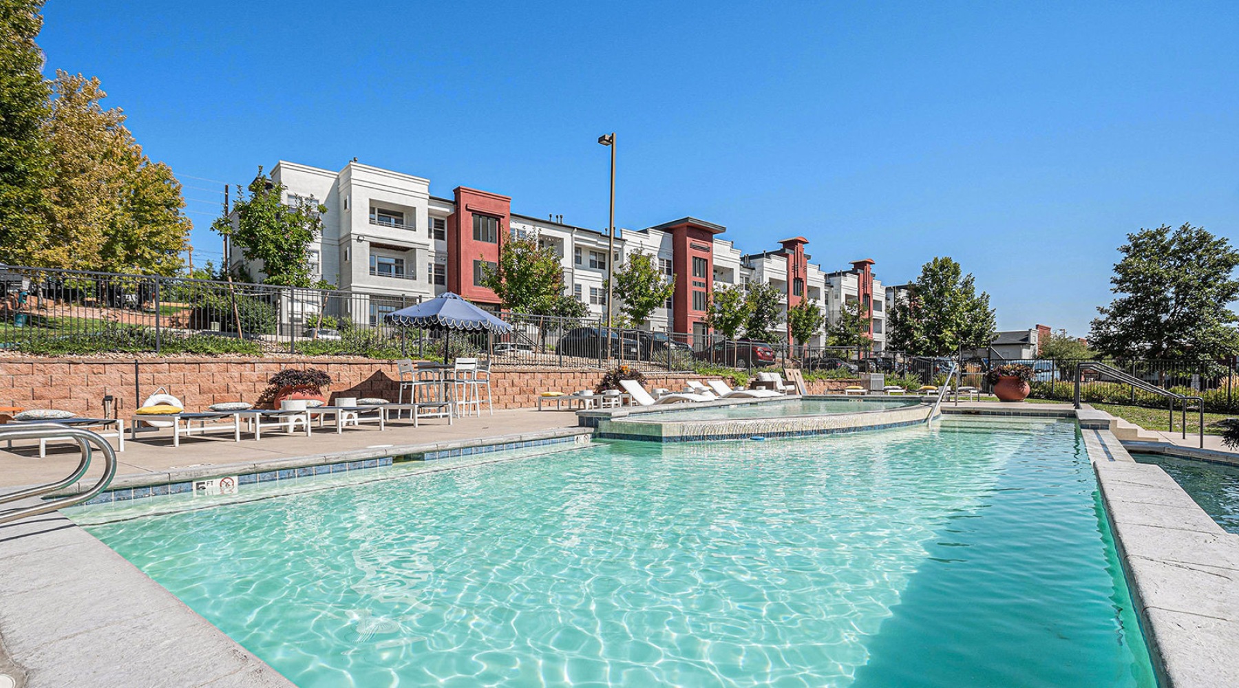 Resort-style swimming pool pool with lounge chairs