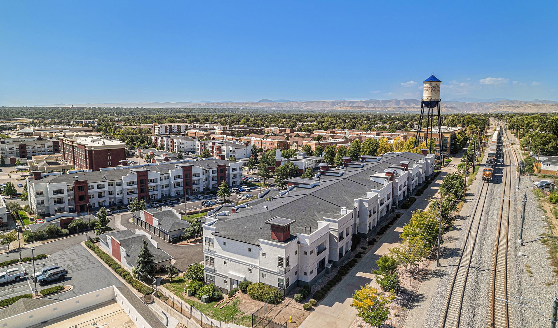 an aerial shot of a neighborhood with a water tower