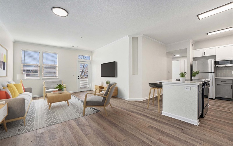Open concept living room with couches and vinyl flooring
