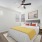 a bedroom with multiple windows and ceiling fan