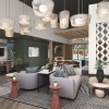 Couches and comfy chairs with tables and TVs